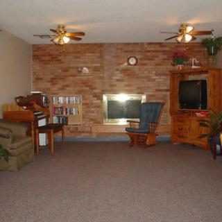A cozy living room with a fireplace, television, and comfortable seating.