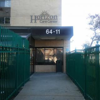 Entrance to Horizon at address 64-11, featuring a green fence.