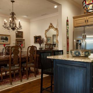 A beautifully decorated dining room featuring elegant furniture and warm lighting.