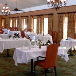 Elegant dining area with neatly arranged tables and chairs.