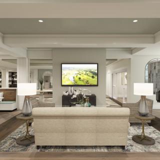 A modern living room featuring a beige sofa, stylish lamps, and a flat-screen TV.