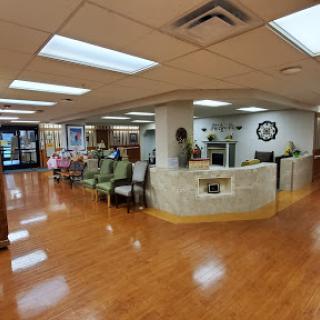 A spacious and welcoming waiting area in a medical facility, featuring comfortable seating and natural light.