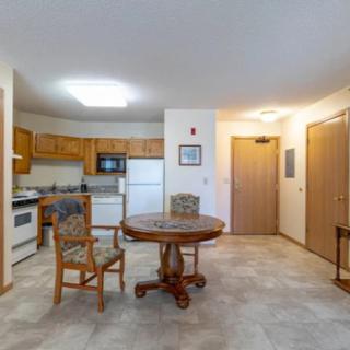 A cozy kitchen and dining area with a round table and wooden chairs.