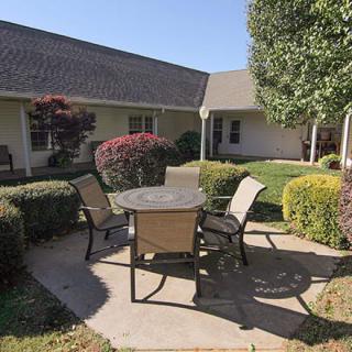 A peaceful courtyard with outdoor seating and well-maintained landscaping.