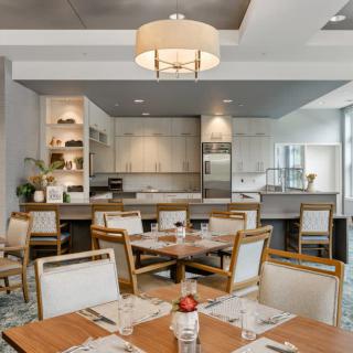 A modern dining area with stylish furniture and an open kitchen concept.