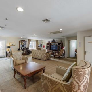 A spacious and elegantly furnished living room with comfortable seating, a coffee table, and stylish decor.