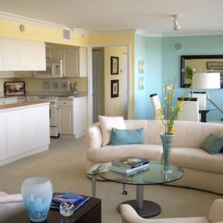 A modern open-plan living room with comfortable sofas and a stylish kitchen area.
