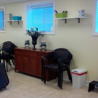 A cozy room with chairs, a table, and decorative elements under a window.
