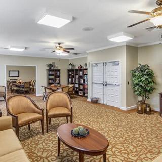 A cozy lounge area with comfortable seating and bookshelves.