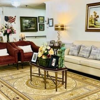 A cozy living room setting featuring comfortable seating, decorative elements, and a warm ambiance.