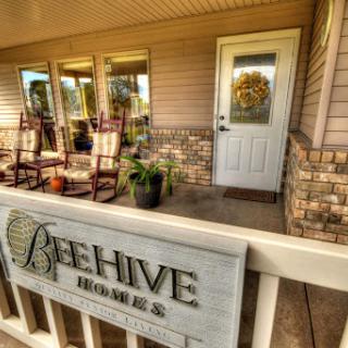Welcoming entrance to Beehive Homes with comfortable rocking chairs.