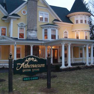 A Victorian-style bed and breakfast inn with a welcoming evening ambiance.