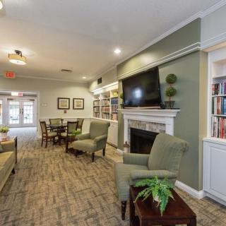 A cozy living room with a fireplace, TV, and comfortable seating.