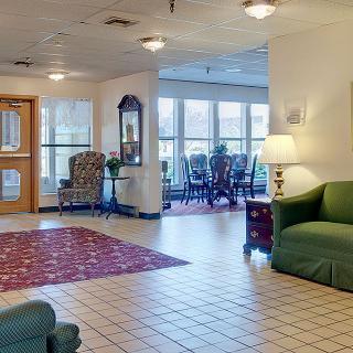 A spacious lobby area with seating, carpet, and ample natural light.