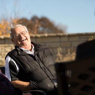 A joyful moment shared between friends in a sunny outdoor setting.