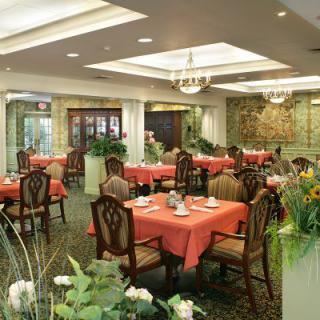 An elegant restaurant dining room with neatly arranged tables and vibrant decor.