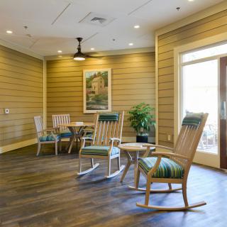 A cozy lounge area with rocking chairs and natural lighting.
