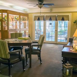 A cozy living and dining area with comfortable seating and large windows.