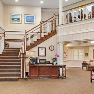Elegant lobby area with a reception desk and staircase.