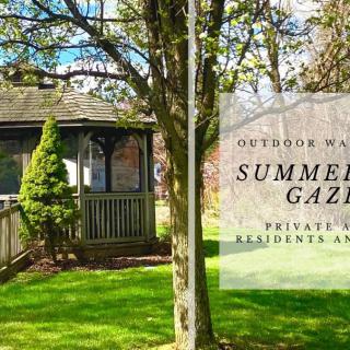 A private summer gazebo surrounded by greenery, exclusive for residents' use.