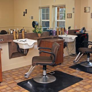 A cozy salon setup featuring styling chairs and wash stations, ready for hair services.