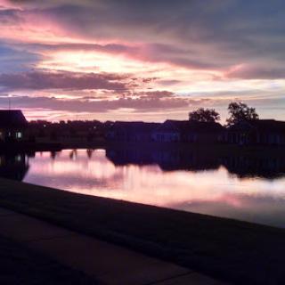A beautiful sunset reflecting on the still waters, creating a serene atmosphere.
