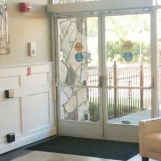 A well-lit lobby entrance with glass doors and comfortable seating.