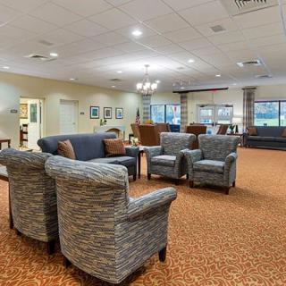 A spacious living room with comfortable seating and warm lighting.