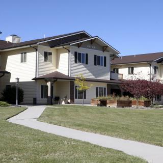 A suburban residential house with a well-maintained lawn and pathway.