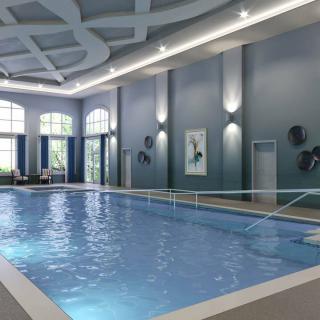 A luxurious indoor swimming pool with modern architectural design and ambient lighting.