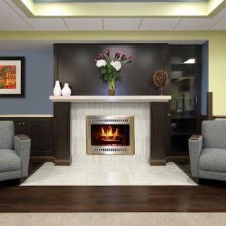 A cozy and modern living room featuring a stylish fireplace and comfortable seating.