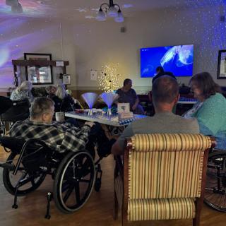 Residents of a care facility enjoying an engaging social activity together.