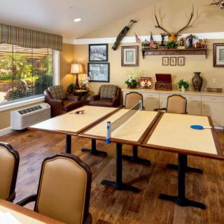 A cozy meeting room with a conference setup, featuring decor including deer antlers and wood accents.