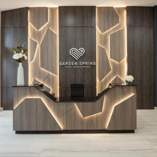 A stylish and modern reception area featuring unique lighting and wood accents.