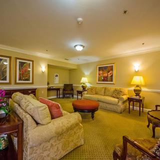 A cozy living room with comfortable sofas and warm lighting.