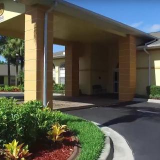 A building entrance with a landscaped driveway.