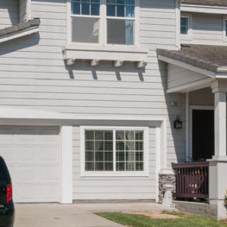 A suburban residential house with a garage and driveway.