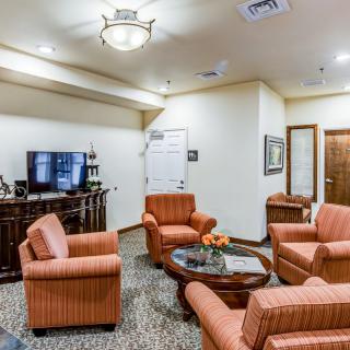 A cozy living room with comfortable seating and a television.