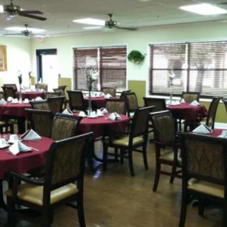 A neatly arranged restaurant dining room with tables set for guests.