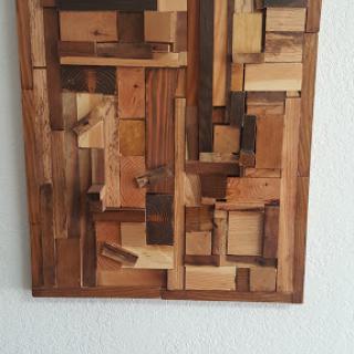 An abstract wooden art piece showcasing a variety of textures and geometric shapes.