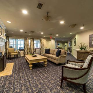 A cozy living room with comfortable seating, a coffee table, and elegant decor.