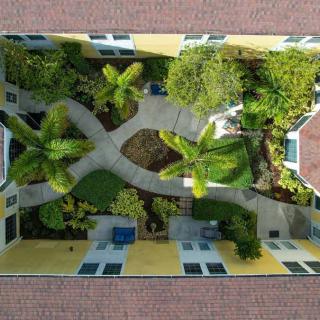 Aerial view of a landscaped courtyard with pathways and lush greenery.