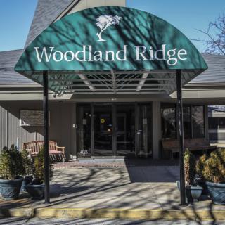 Entrance to Woodland Ridge with a green awning.