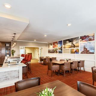 A modern restaurant interior with a seating area and artwork adorning the walls.