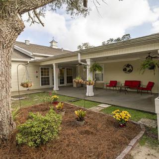 A cozy backyard patio with outdoor seating and a well-maintained garden.