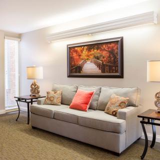 A cozy living room with a comfortable sofa, decorative pillows, and warm lighting.