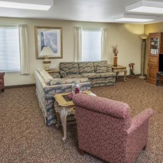 A neatly arranged living room with patterned couches, a coffee table, and decorative items.