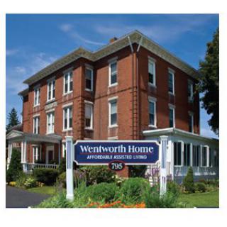 A large brick building with a sign that reads 'Wentworth Home, Assisted & Supported Living'.