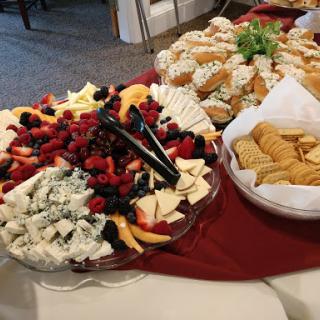 An elegant spread of assorted fruits, cheeses, and cookies perfect for a gathering.