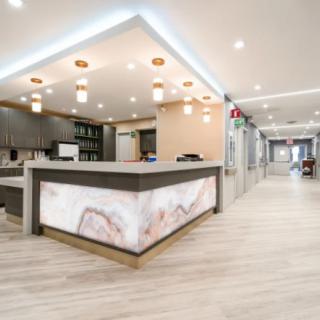 A modern reception area with stylish lighting and a marble counter.